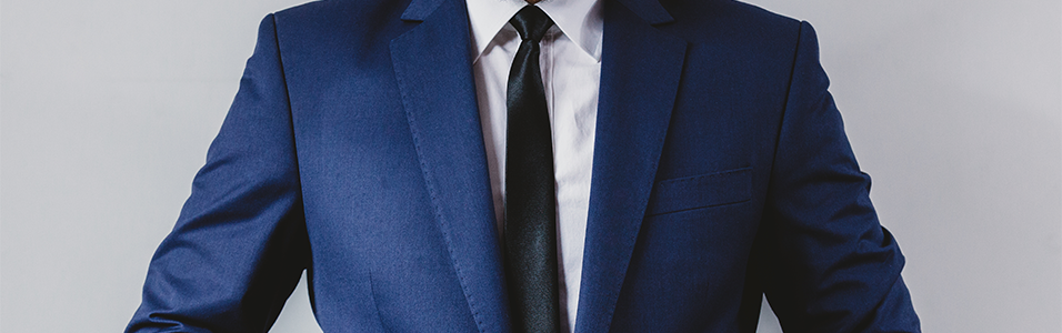 A headless image of a Professional blue and black suit, the background is grey.